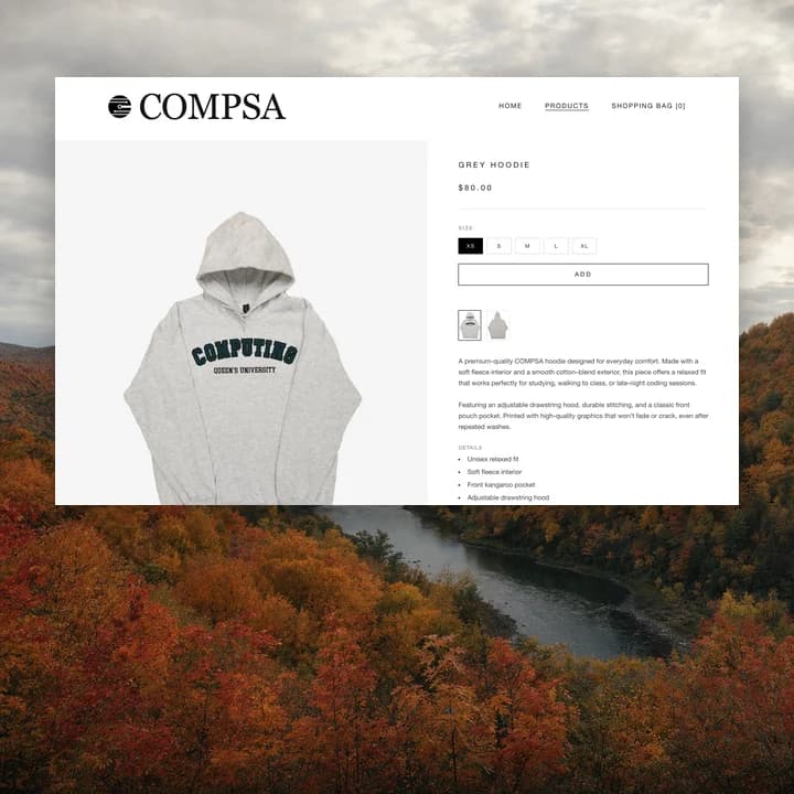 The grey hoodie product page floating over autumn hills and a river