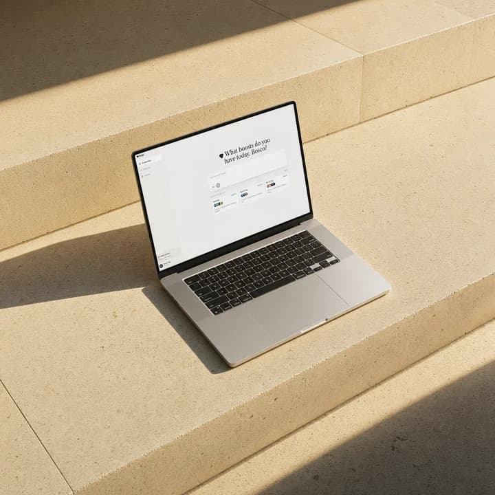 The Pobi app on a MacBook resting on sunlit stone steps